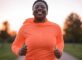 Person jogging at sunrise with a happy expression