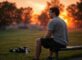 Person relaxing outdoors with a sunrise, weights nearby